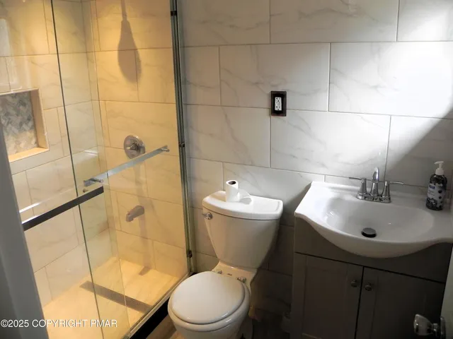 a bathroom with a sink toilet and shower