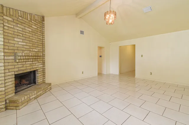 a view of empty room with a fireplace