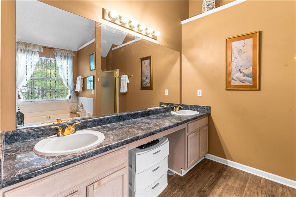 3234 Mineral Ridge Lane Stone Mountain, GA 30087 - Photo 29 of 55 a bathroom with a granite countertop sink a mirror and a window