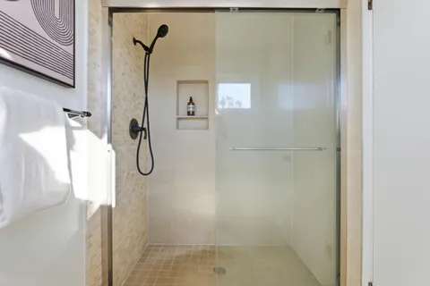 a bathroom with double vanity and a mirror