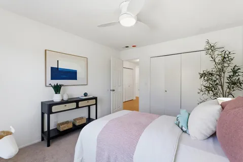 a bedroom with a bed and a lamp with window