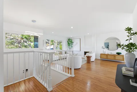 a living room with furniture and a potted plant