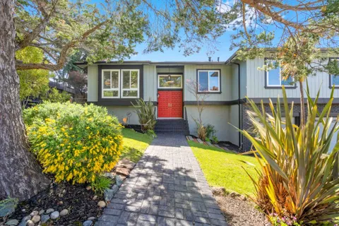 a living room with furniture a fireplace and a table