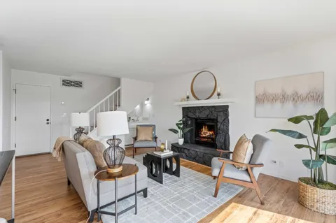 a front view of a house with a yard and a garden