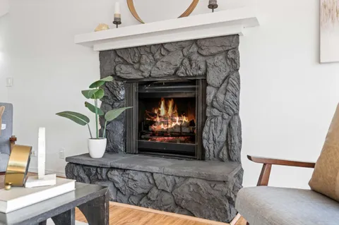 a front view of a house with a garden and yard