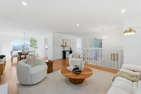 a living room with furniture a fireplace and a potted plant