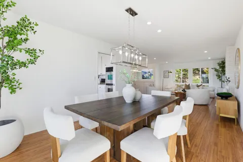 a large kitchen with granite countertop a large counter top stainless steel appliances and cabinets