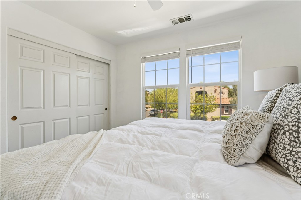 4155 Windspring Street Corona, CA 92883 - Photo 30 of 38 a bedroom with a bed and a window