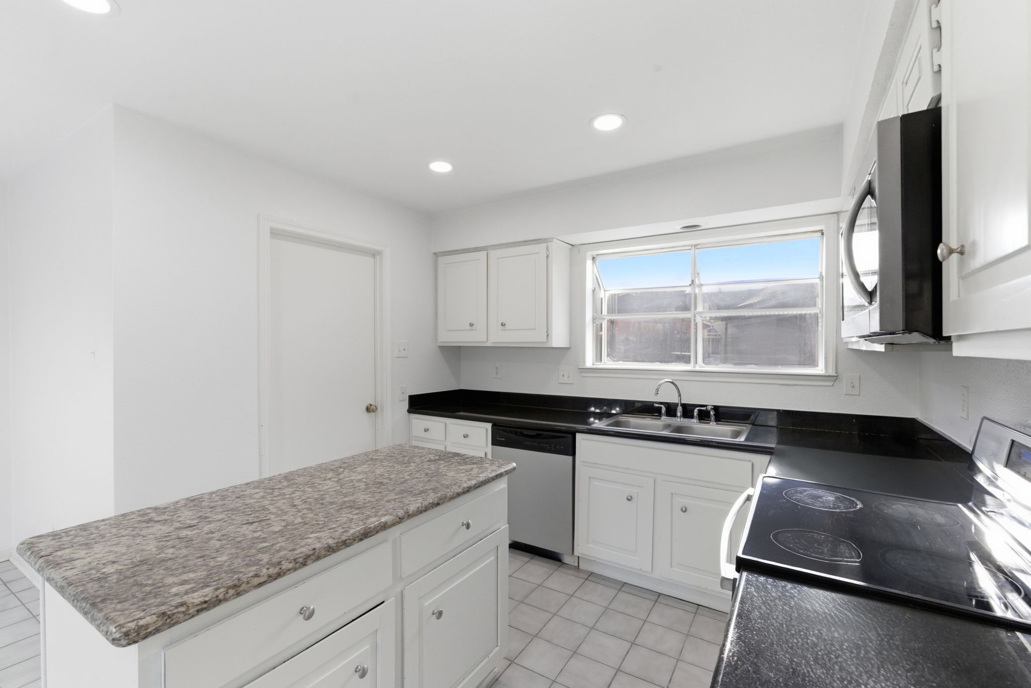 506 Willow Wisp Circle Spring, TX 77388 - Photo 15 of 38 a kitchen with granite countertop a sink stove and cabinets