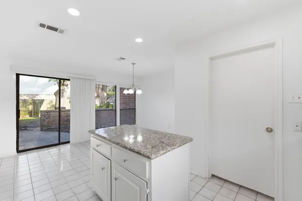 a kitchen with granite countertop a sink and a stove