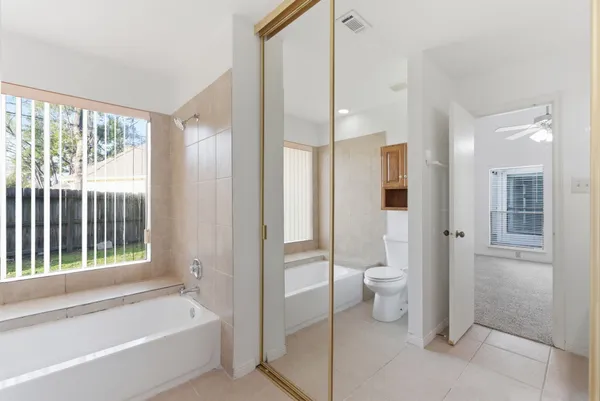 a bathroom with a tub and shower