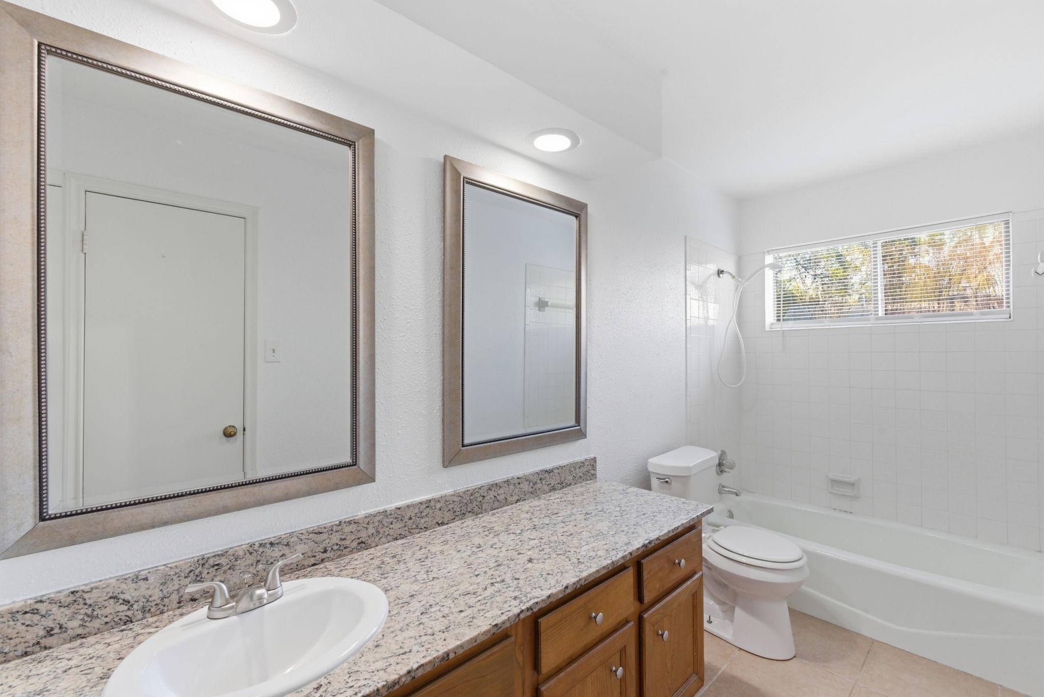 506 Willow Wisp Circle Spring, TX 77388 - Photo 30 of 38 a bathroom with a granite countertop sink toilet a large mirror and shower