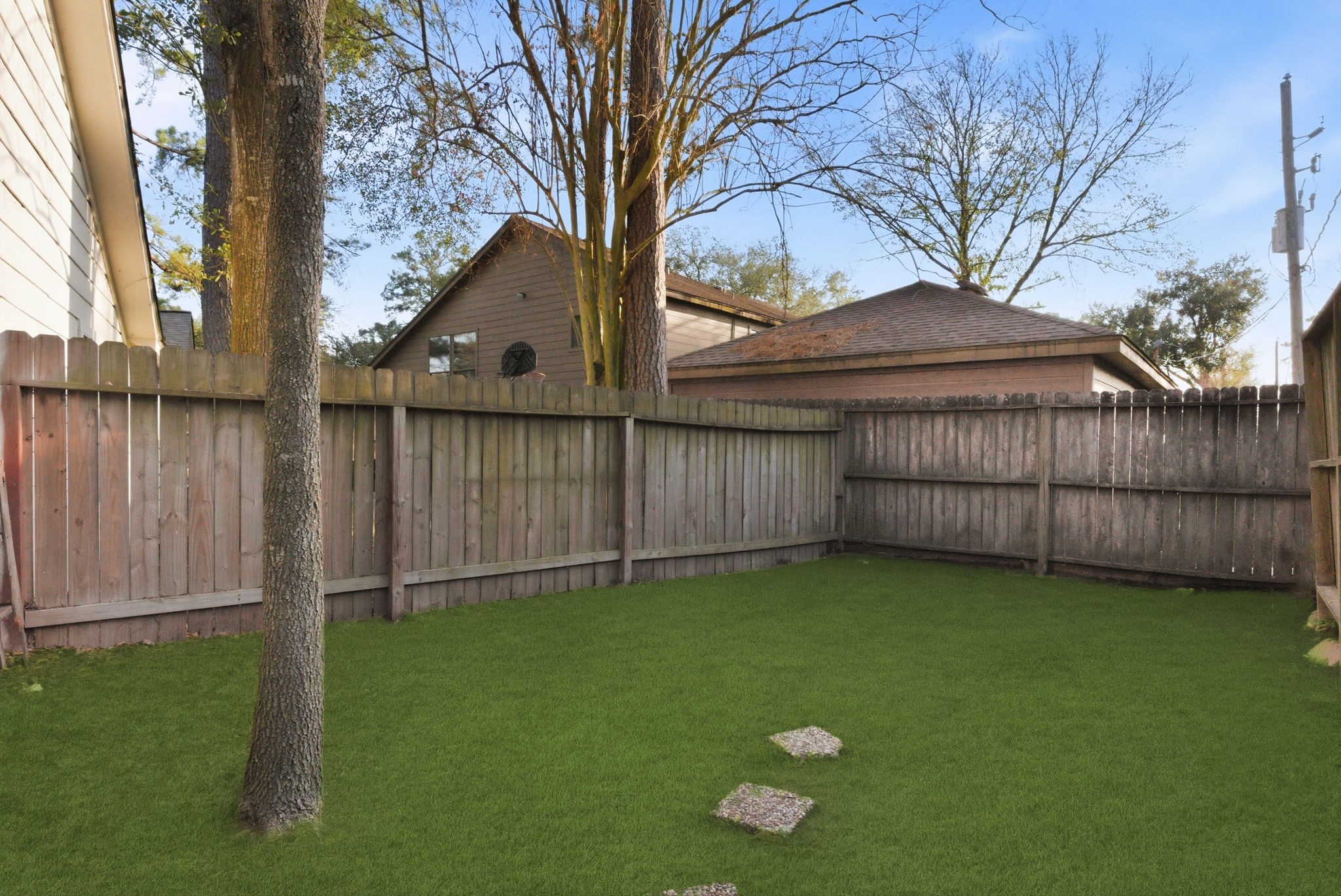 506 Willow Wisp Circle Spring, TX 77388 - Photo 33 of 38 a view of a backyard with a small cabin and wooden fence