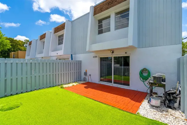 a view of a backyard with a small cabin and chair
