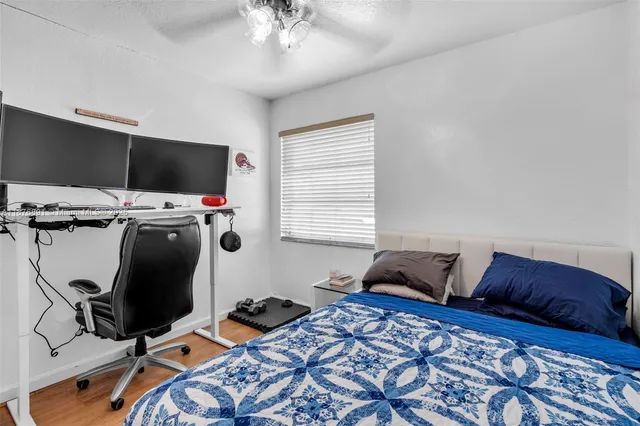 a bedroom with furniture and a flat screen tv