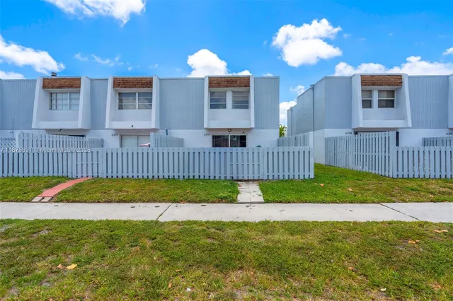 a view of a house front of a house with a yard and a porch