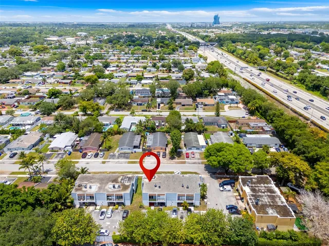 an aerial view of residential houses with outdoor space
