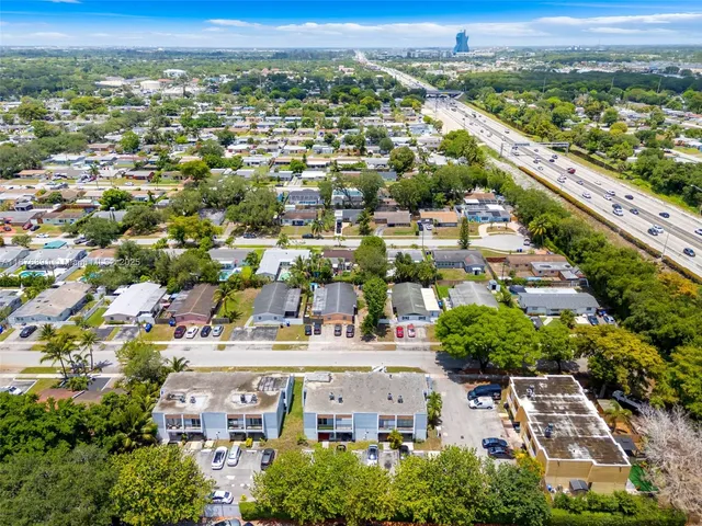 an aerial view of residential houses with city view