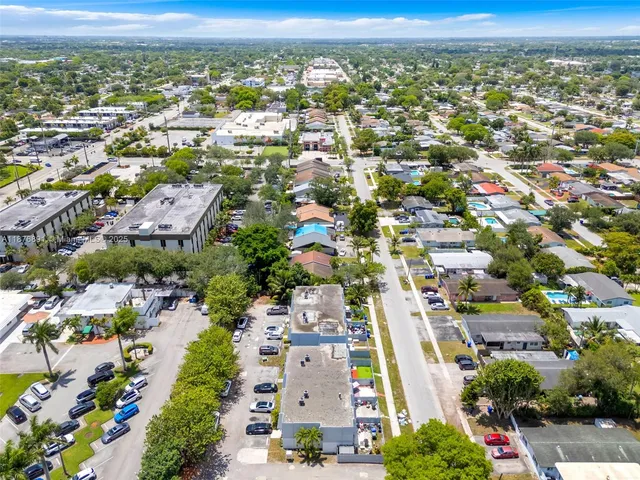 an aerial view of residential building with green space