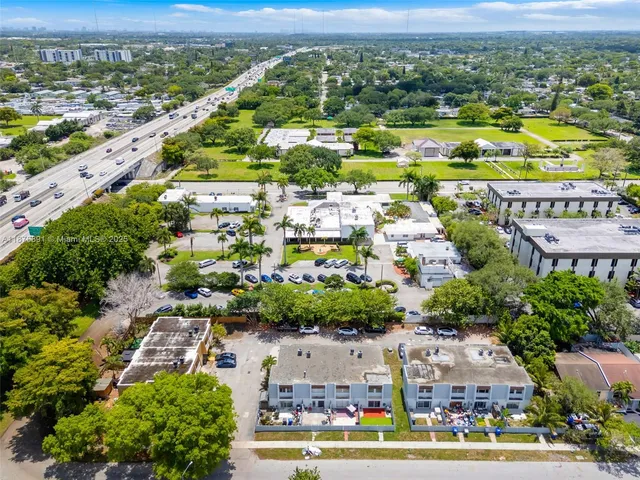 an aerial view of residential houses with outdoor space