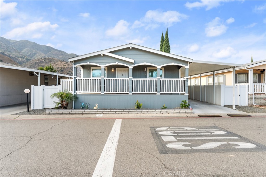 4901 Green River Road, Unit 96 Corona, CA 92878 - Photo 1 of 35 a front view of a house with a garden