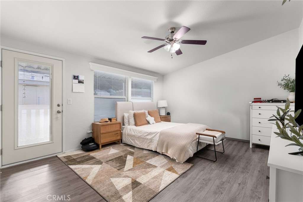 4901 Green River Road, Unit 96 Corona, CA 92878 - Photo 15 of 35 a bedroom with a bed and wooden floor
