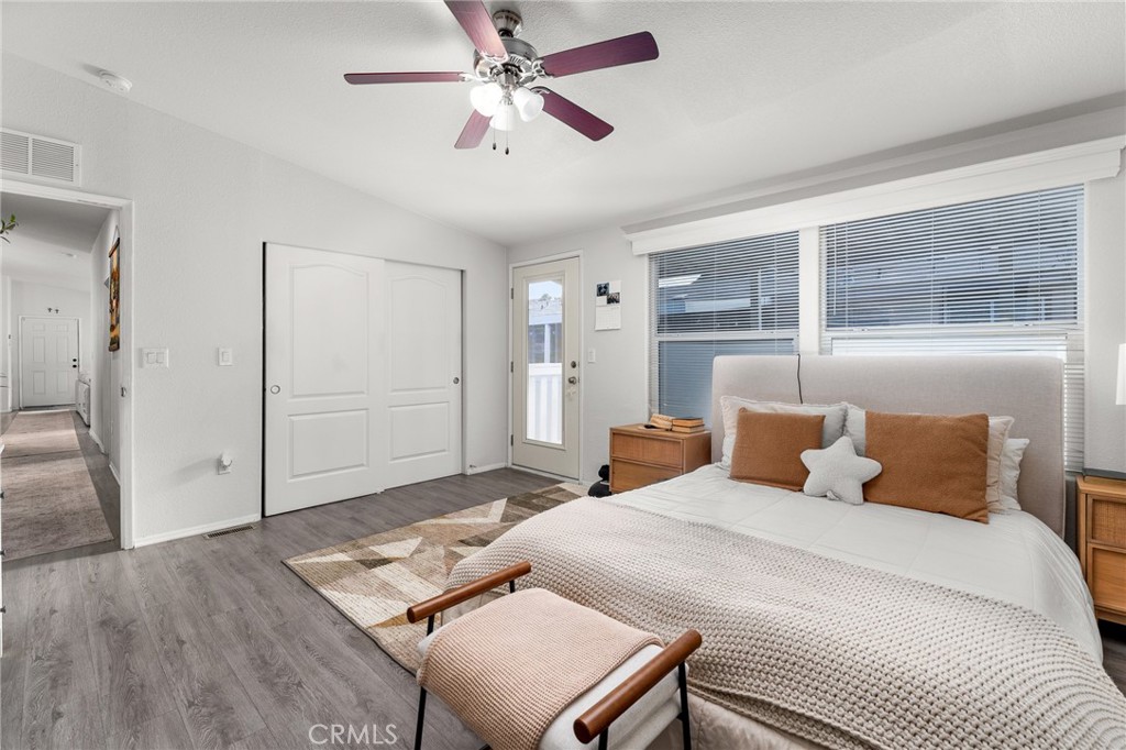 4901 Green River Road, Unit 96 Corona, CA 92878 - Photo 16 of 35 a bedroom with a bed and a chandelier