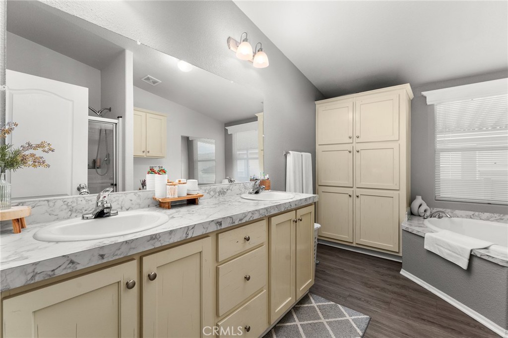 4901 Green River Road, Unit 96 Corona, CA 92878 - Photo 17 of 35 a bathroom with a sink double vanity granite tub and shower