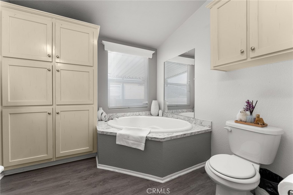 4901 Green River Road, Unit 96 Corona, CA 92878 - Photo 18 of 35 a bathroom with a sink a toilet and vanity