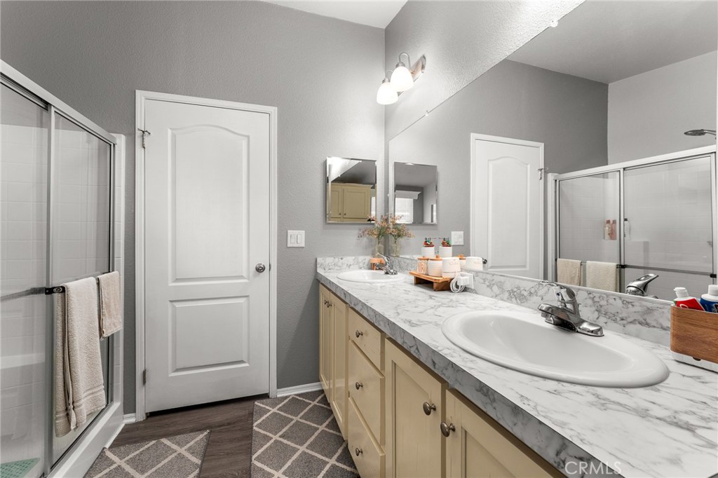4901 Green River Road, Unit 96 Corona, CA 92878 - Photo 22 of 35 a bathroom with a double vanity sink and mirror