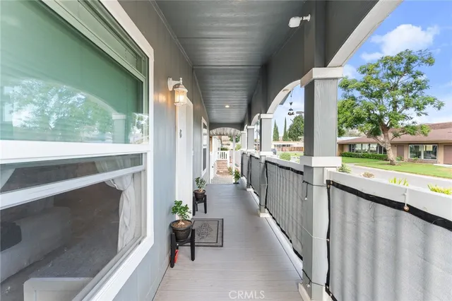 a view of a porch with furniture and a yard