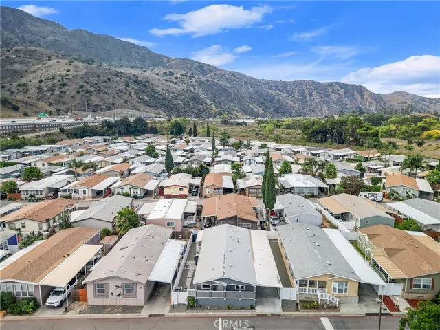 an aerial view of residential house with outdoor space and mountain view
