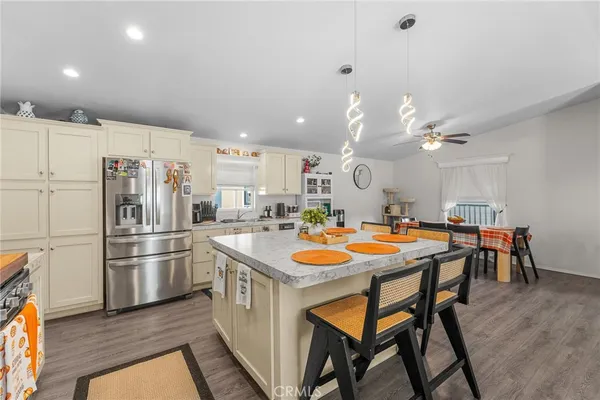 a kitchen with stainless steel appliances granite countertop a sink and a refrigerator