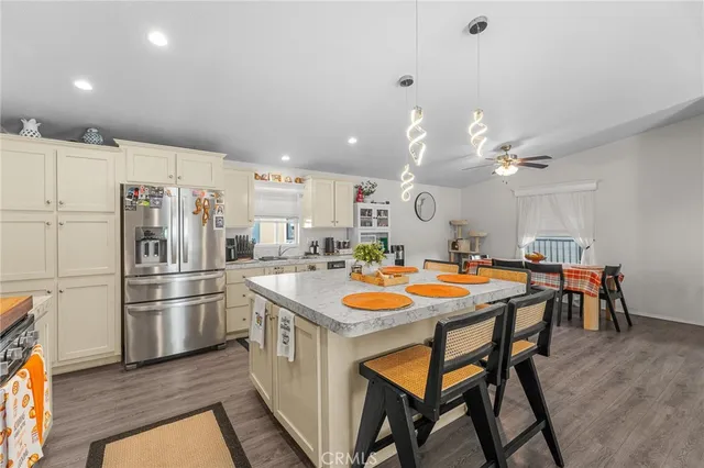 a kitchen with stainless steel appliances granite countertop a sink and a refrigerator