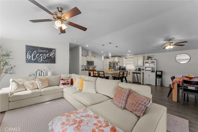 a living room with furniture kitchen and a chandelier