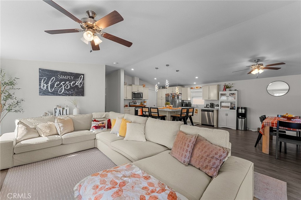 4901 Green River Road, Unit 96 Corona, CA 92878 - Photo 10 of 35 a living room with furniture kitchen and a chandelier