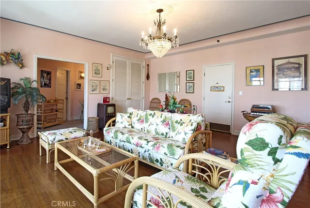 a bedroom with bed and a chandelier