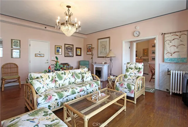 a living room with furniture dining table and a chandelier