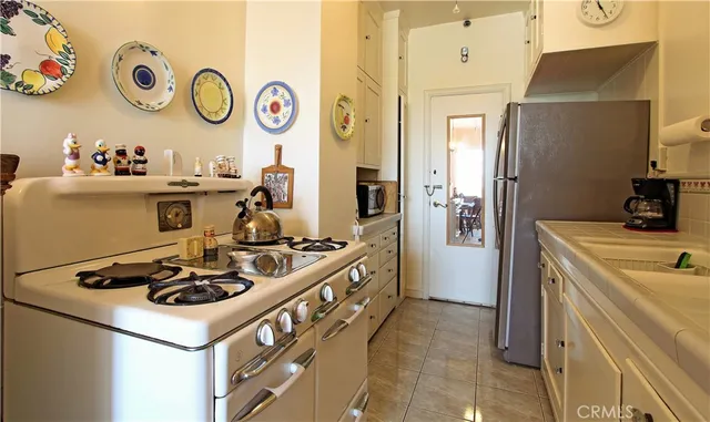 a kitchen with a stove and a refrigerator