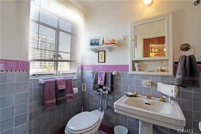 a bathroom with a sink toilet and mirror