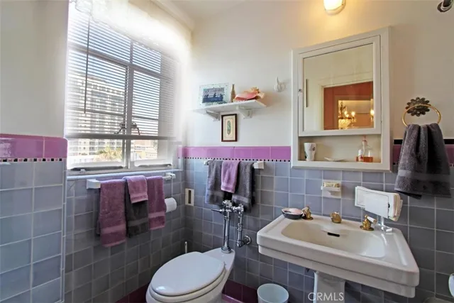 a bathroom with a sink toilet and mirror