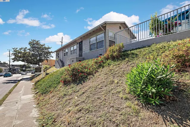 a view of a house with a yard and pathway