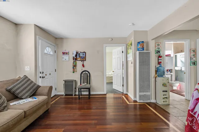 a living room with furniture bathtub and a wooden floor