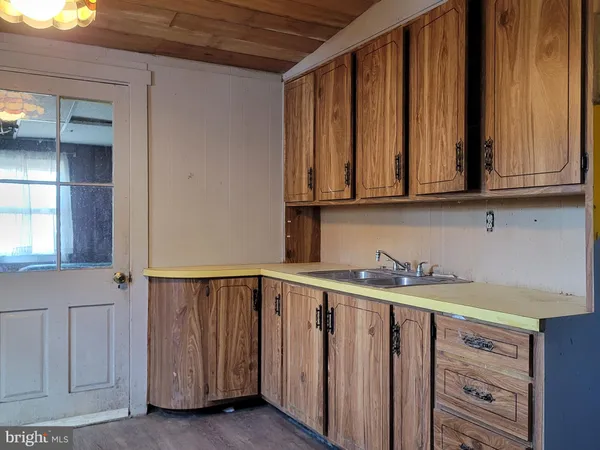 a view of a kitchen with grey cabinets