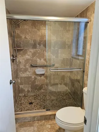 a bathroom with a shower and a toilet