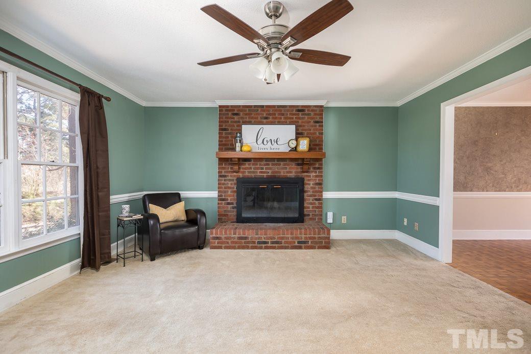 1605 Pagan Road Raleigh, NC 27603 - Photo 4 of 23 a living room with furniture a window and a fireplace