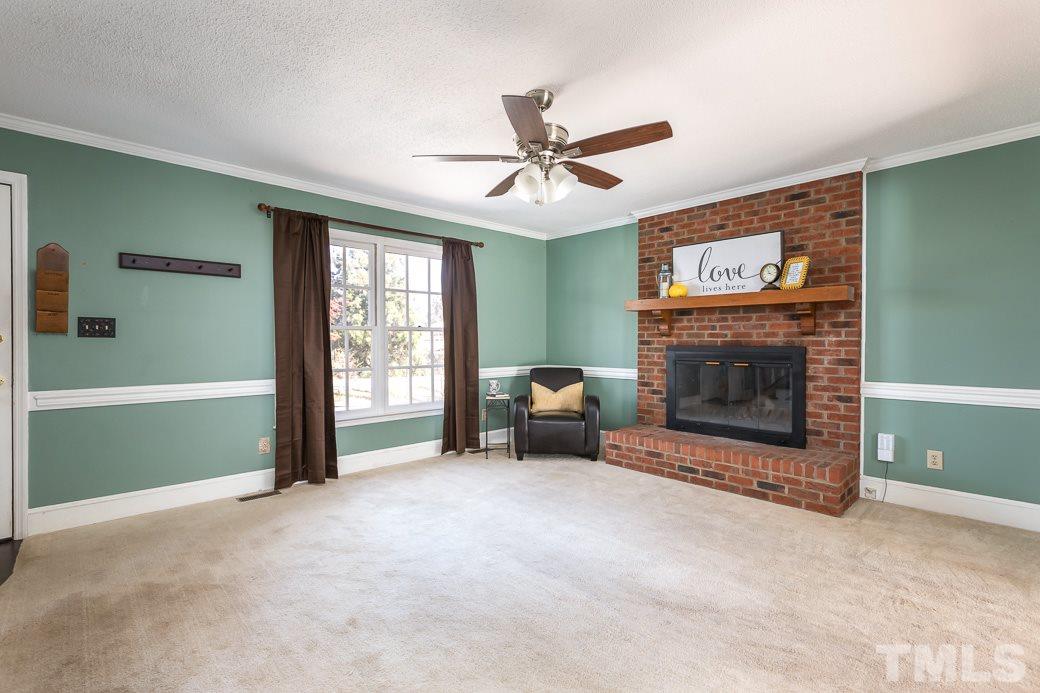 1605 Pagan Road Raleigh, NC 27603 - Photo 5 of 23 a living room with furniture and a fireplace