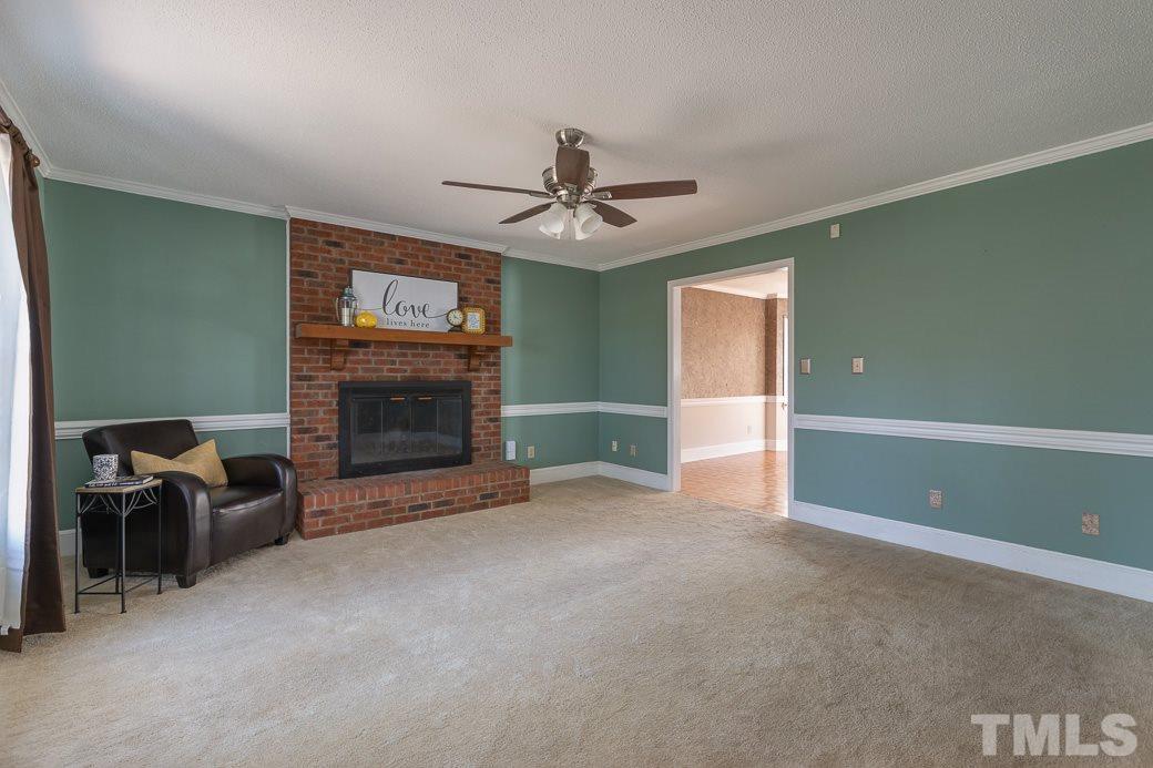 1605 Pagan Road Raleigh, NC 27603 - Photo 6 of 23 a view of a livingroom with a fireplace and window