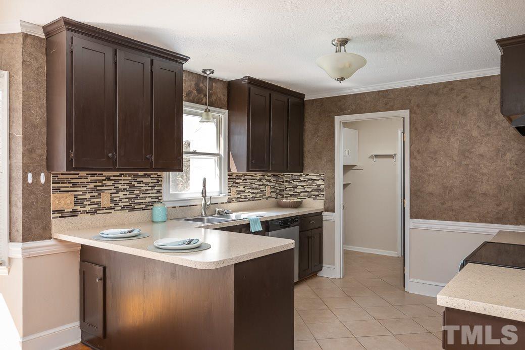 1605 Pagan Road Raleigh, NC 27603 - Photo 8 of 23 a kitchen with a sink stove and cabinets
