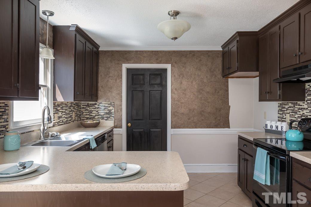 1605 Pagan Road Raleigh, NC 27603 - Photo 9 of 23 a kitchen with a sink and a stove